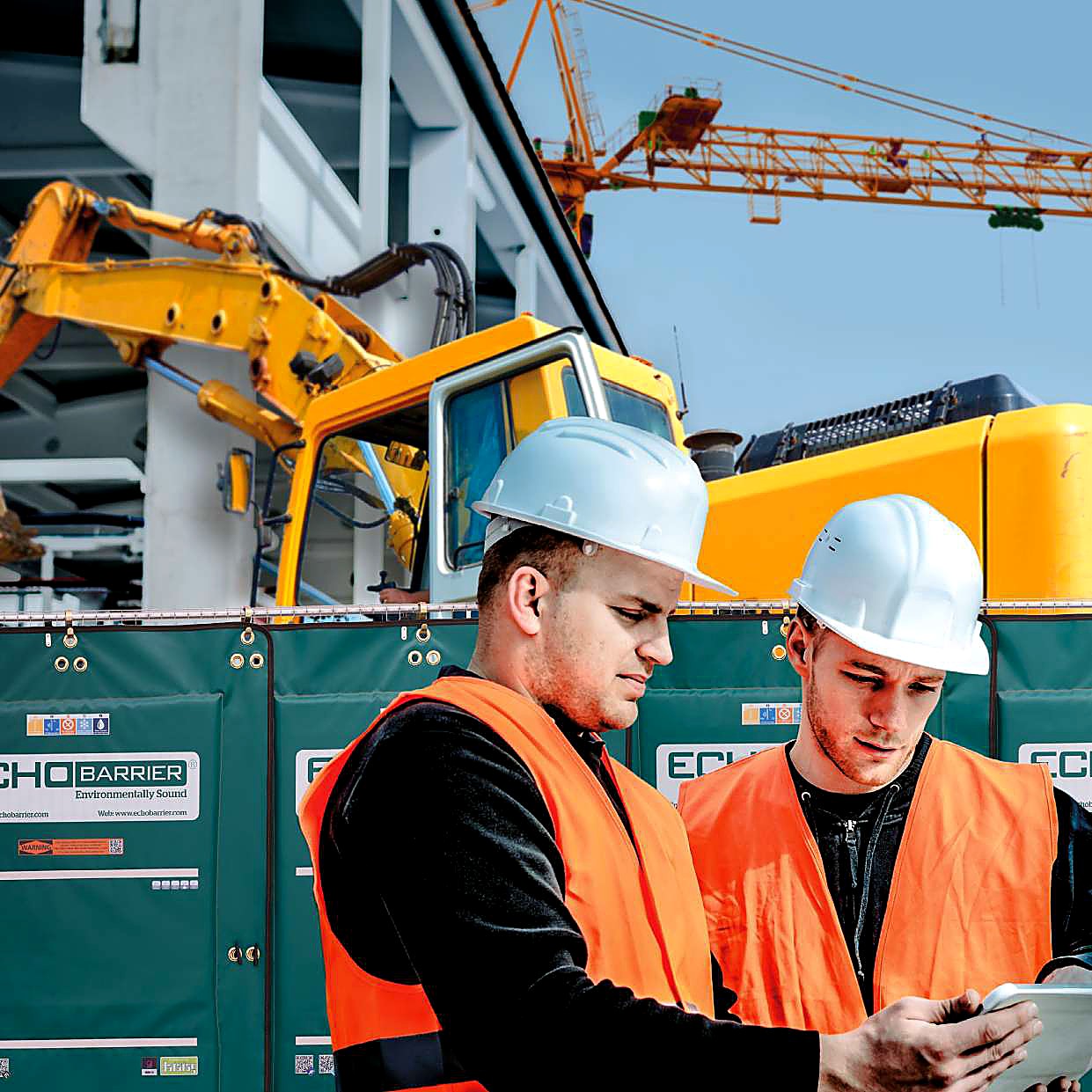 Site workers next to Echo Barrier panels