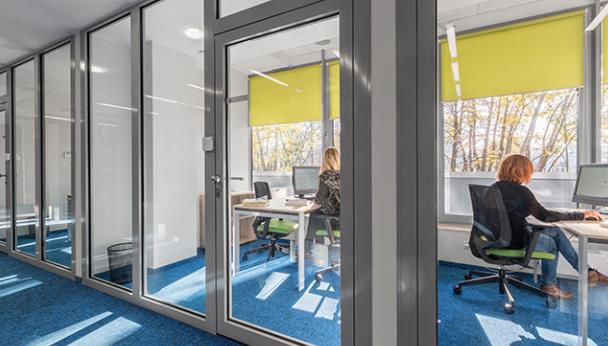 Glass-walled meeting room sound masking — speakers outside the room ensure conversation confidentiality despite thin partitions