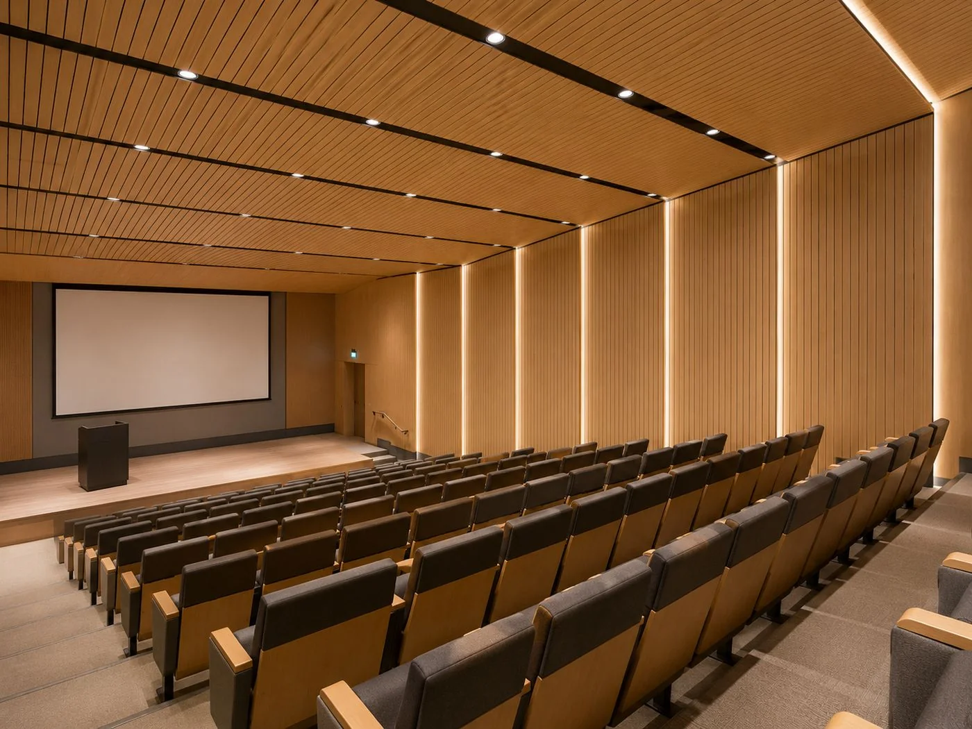 Grooved wood panels in auditorium | ألواح خشب مخدّدة في قاعة محاضرات