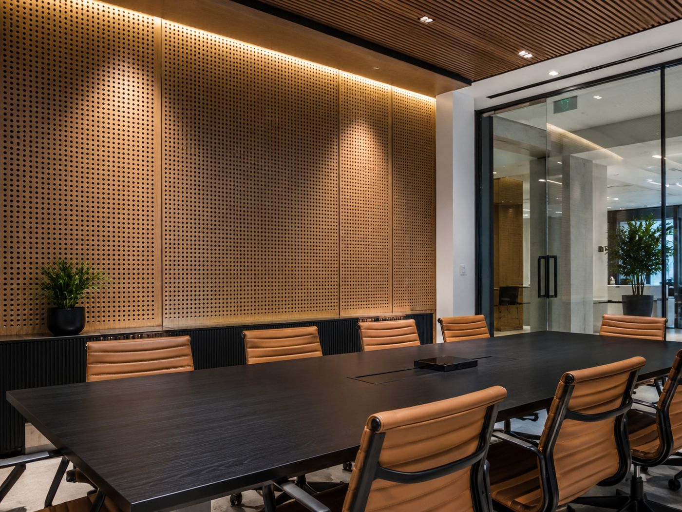 Perforated walnut panels in meeting room | ألواح جوز مثقبة في غرفة اجتماعات
