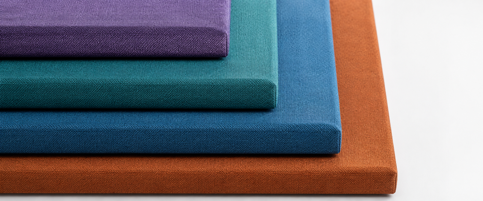 Stacked multi-color fabric acoustic panel samples — Camira texture close-up by Yamamah Smart