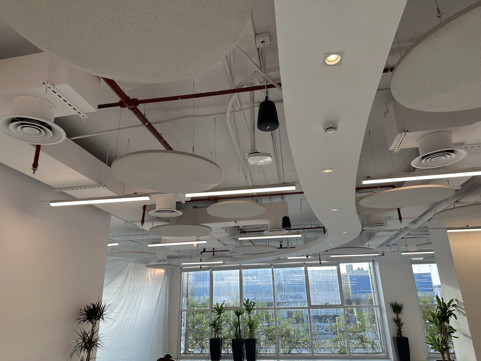 HungerStation HQ — circular baffles over collaboration zone
