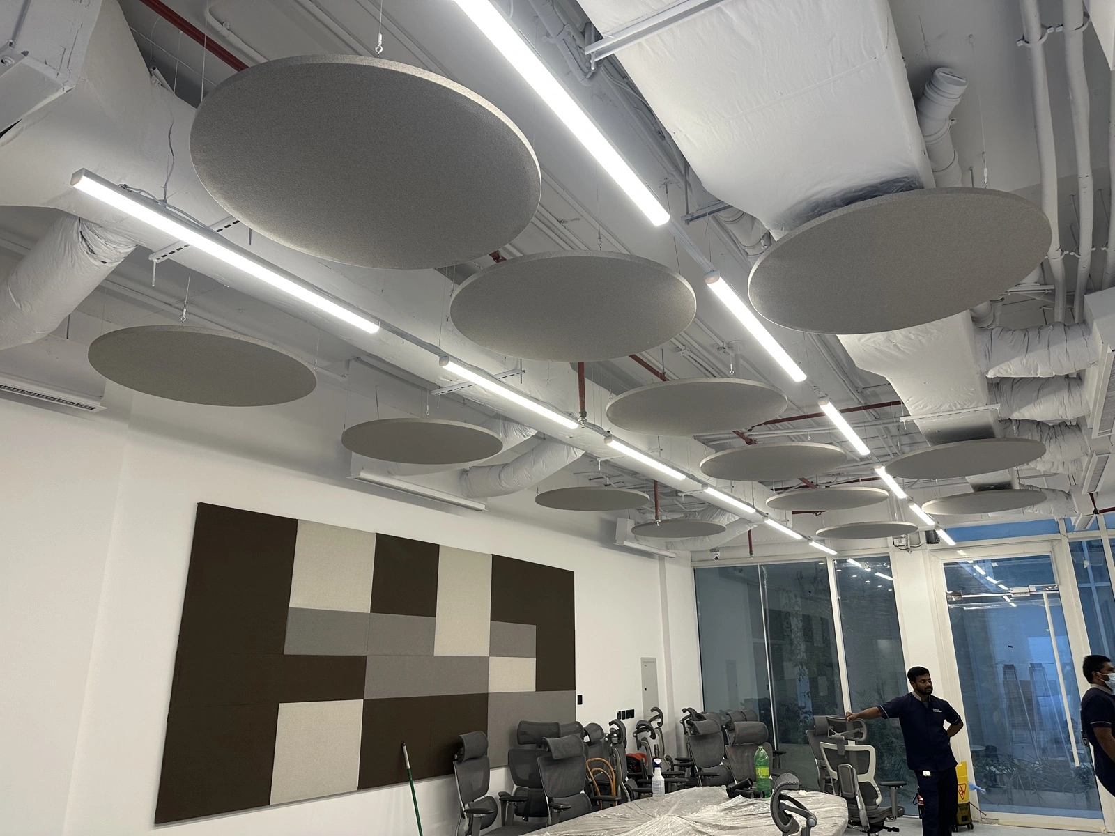 HungerStation HQ — meeting room with checkered fabric wall and baffles