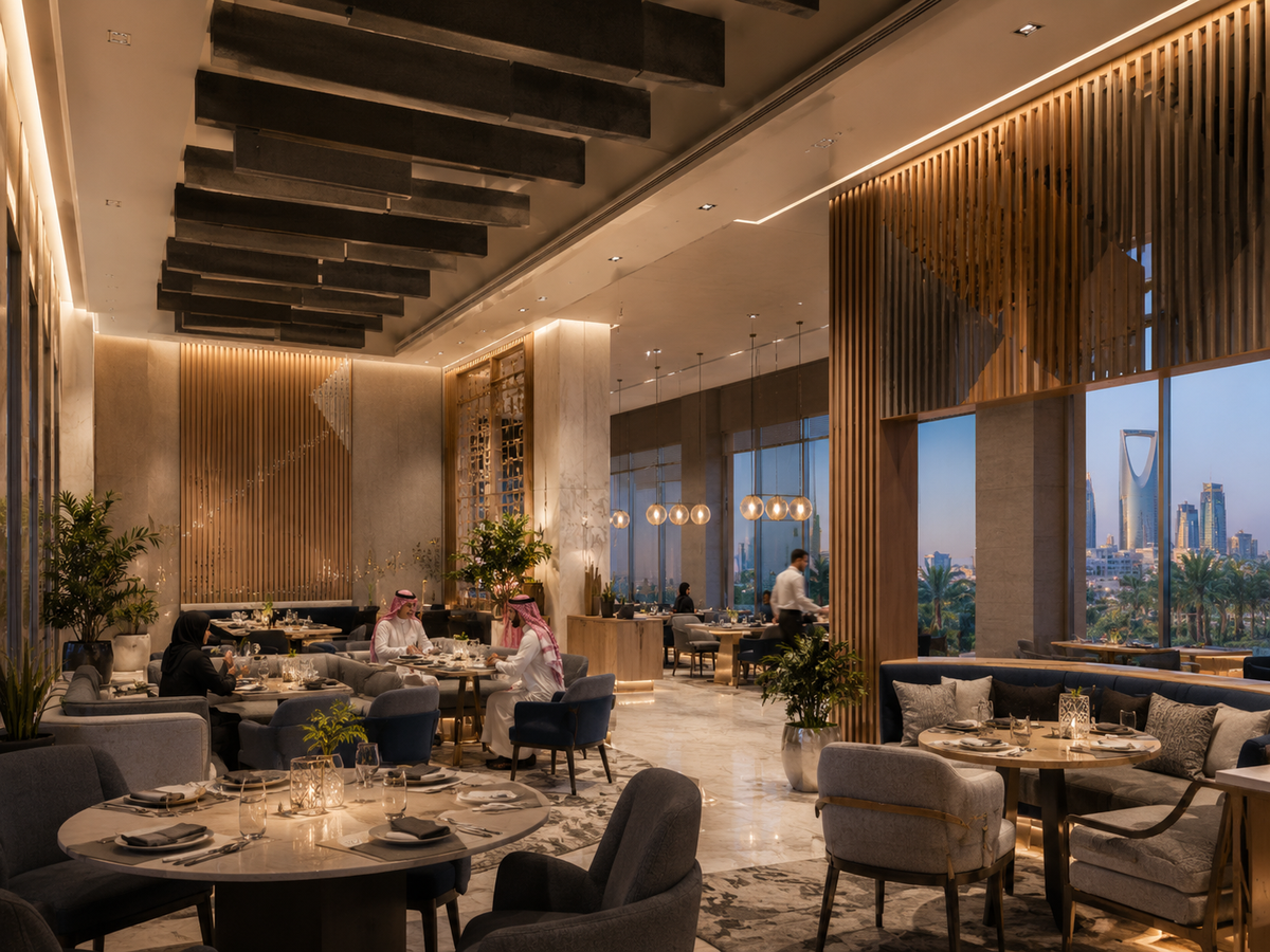 Premium Riyadh restaurant with acoustic ceiling baffles, vertical wood slat dividers, and treated soft seating zones — Kingdom Tower skyline view