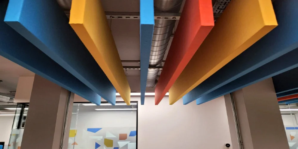 Colorful vertical linear fabric baffles in modern office