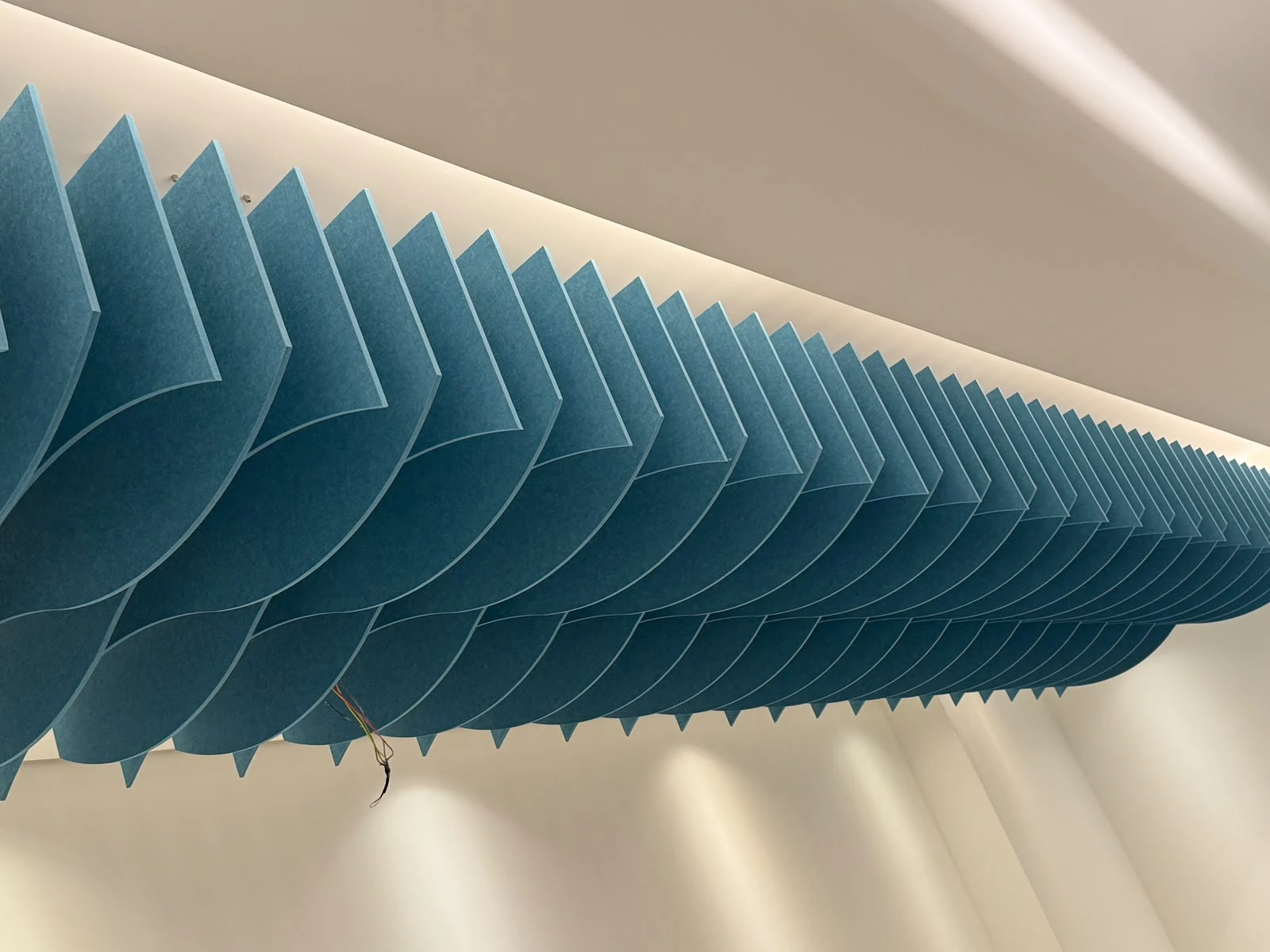 Alpha Capital HQ — PET Wave Ceiling Baffles + Groove Wall Panels · The Esplanade Riyadh